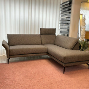 Modernes Ecksofa Violetta Modell Tilda in grauer Stoffausführung auf rosa Teppich – Ausstellungsstück im Möbelhaus Zeppenfeld in Olpe.